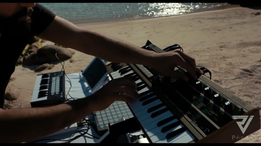 3 - DJ playing keyboards at Cala Coticcio beach